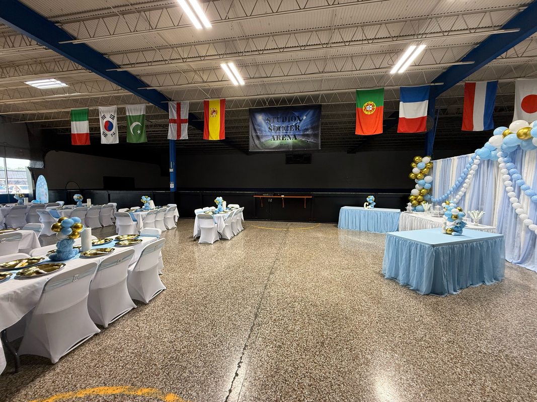Formal baby shower event at StudioX Soccer Arena with decorated tables, balloon arch and draping